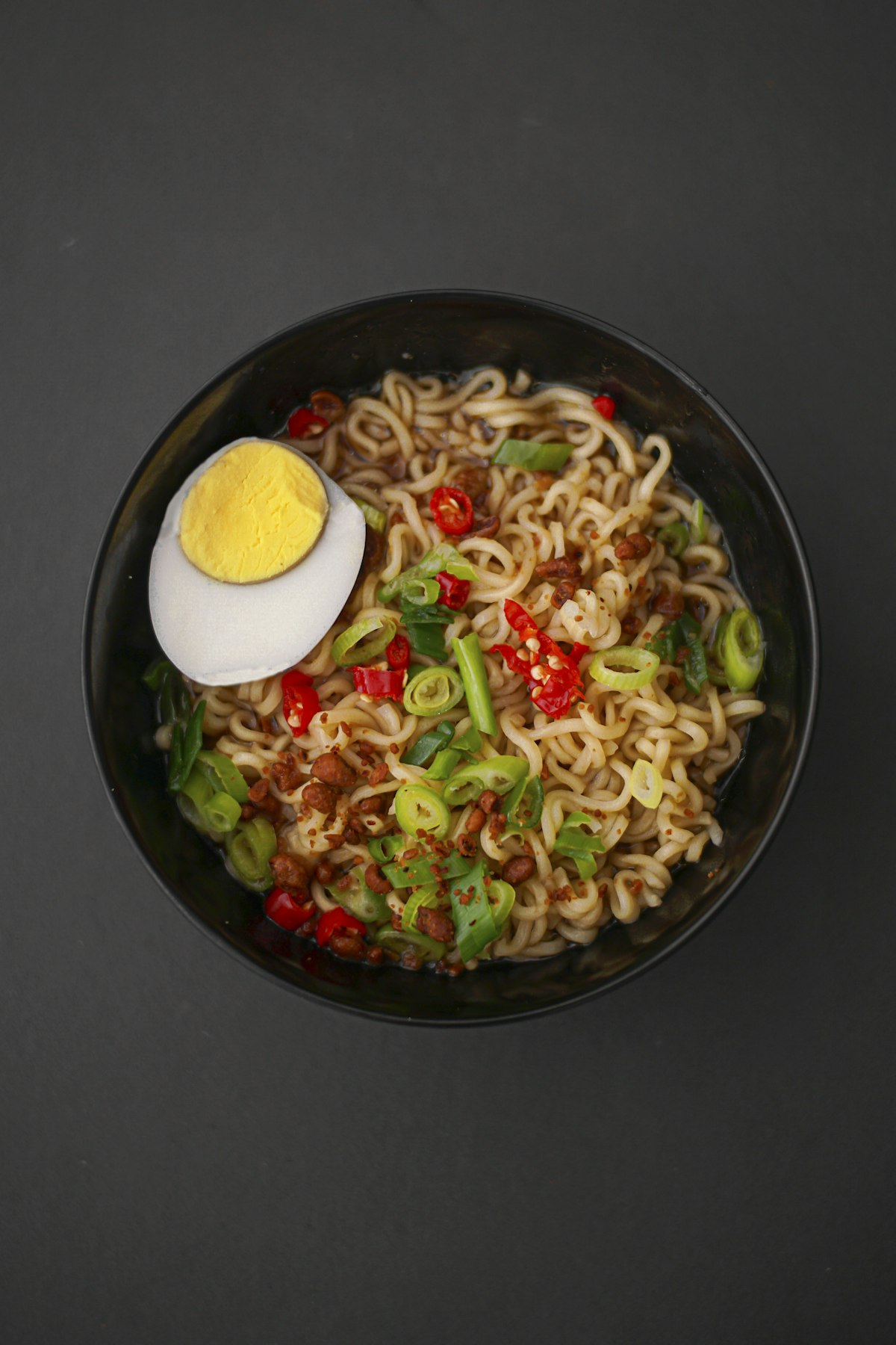 A steaming bowl of Asian noodles